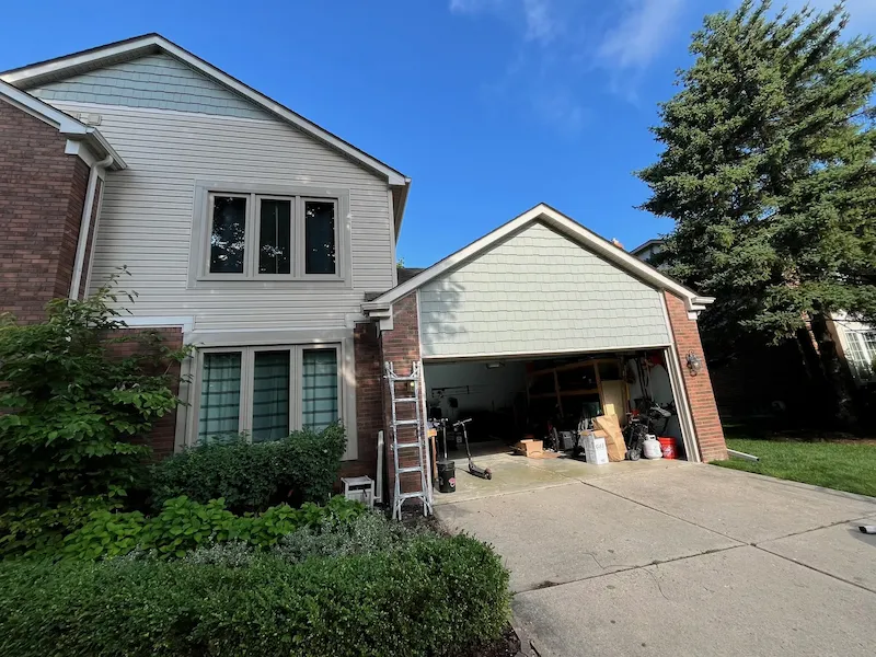 Two-story home with completed siding, windows, and exterior trim