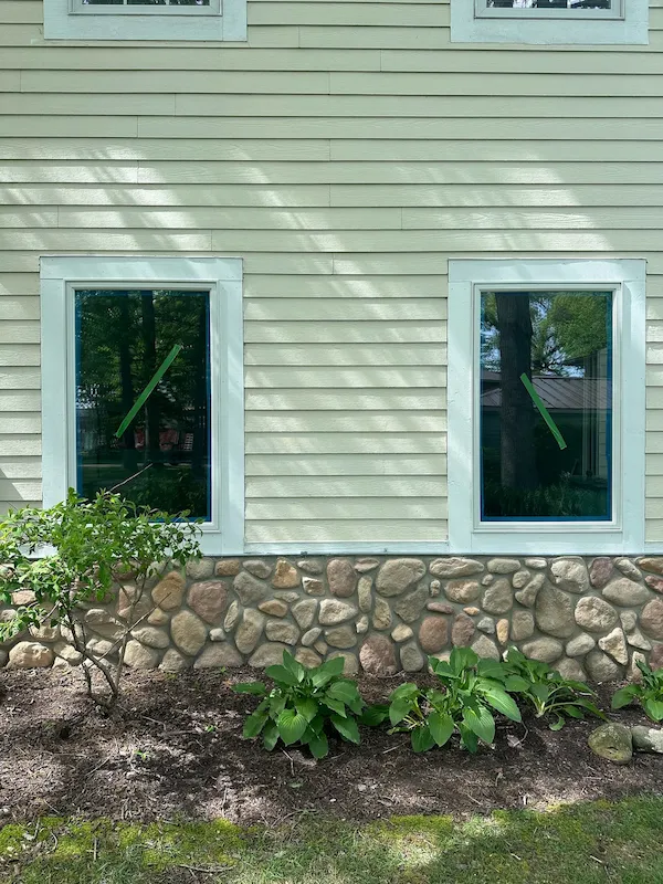 Replacement windows installed above a stone exterior wall