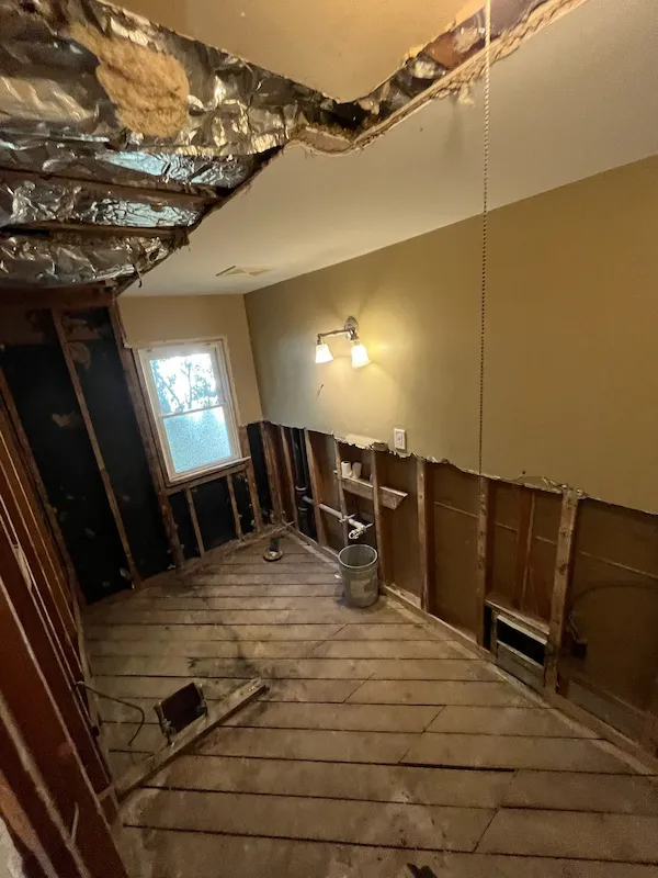 Bathroom stripped to wall studs and subfloor during demolition